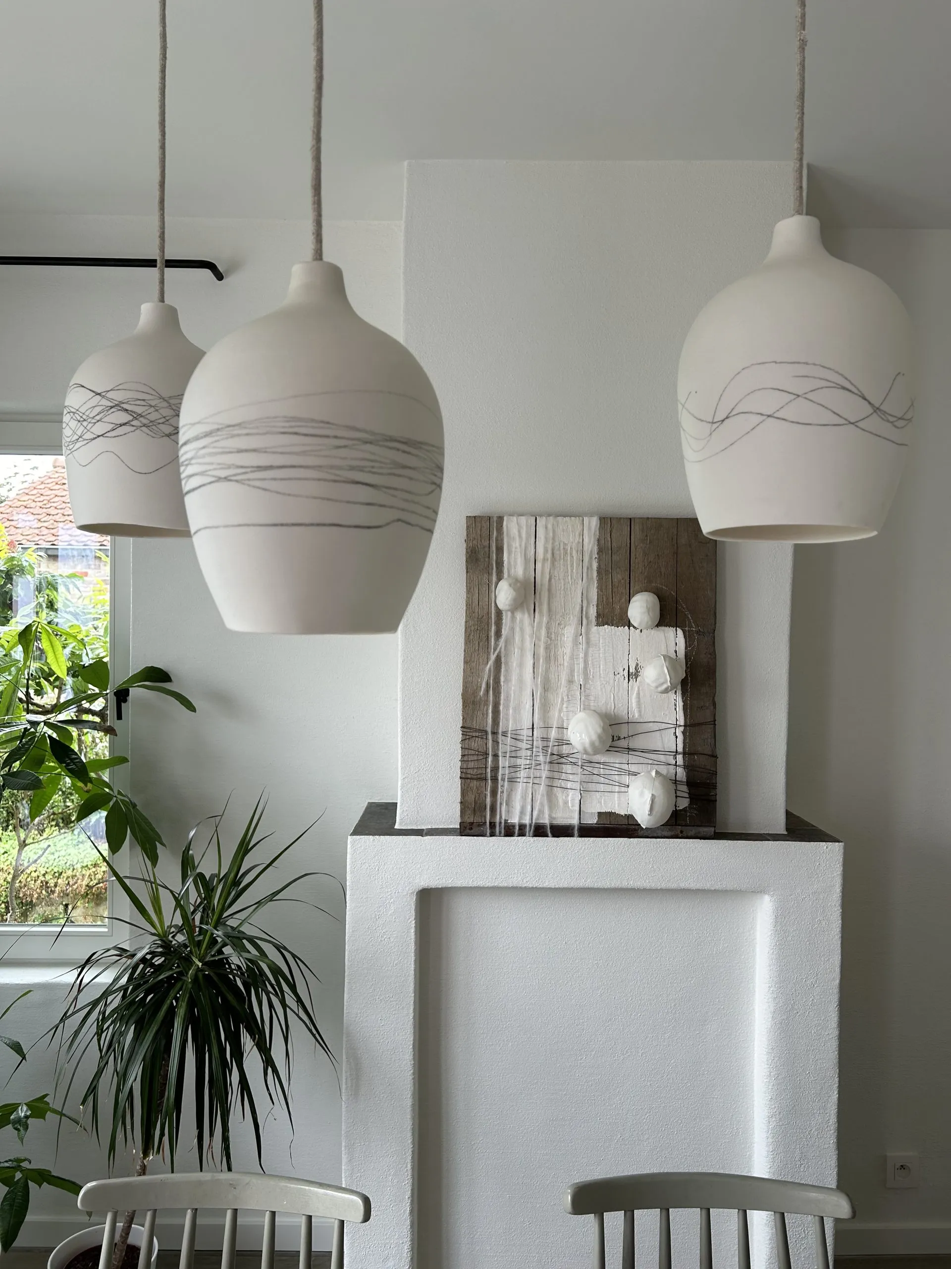 Open kitchen with handmade ceramic tiles and wooden shelving